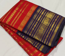 Vaibhogam- Gorgeous Red with Deep Blue Handwoven Pure 2g Jari Kanjivaram Silk with beautiful Jari veldhari striped body with different patterns rich varisaipet borders gorgeous pallu and contrast deep blue jari woven blouse