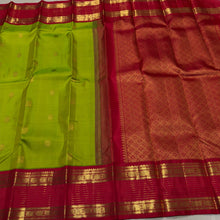 Vaibhogam- Gorgeous Parrot Green with Red Handwoven Pure Zari Korvai Kanjivaram Silk with Buttas woven body with rich doublepet vairaoosi borders with rudrakshas woven beautiful rich pallu and contrast woven red blouse