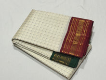 Offwhite with Arakku Red and Emerald Green Ganga Jamuna Korvai Borders with Plus buttas in silk threads woven all over the body with rich arakku pallu and simple green pallu on the other side which can be worn on either sides with a single arakku blouse