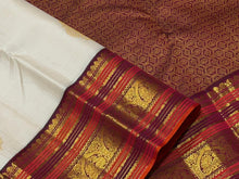 Vaibhogam-Mesmerizing Offwhite with Deep Maroonish Brown Handwoven Pure Jari Korvai Kanjivaram Silk with beautiful buttas gorgeous varisaipet borders rich pallu and contrast woven blouse