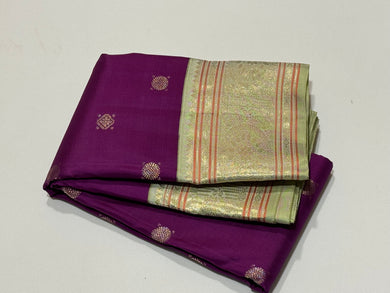 Deep Purple with Elakka Green in Kai Korvai Buttas Kanjivaram Silk Saree with beautiful diamonds and rudrakshas woven body intricate thambalam motifs woven borders rich pallu and contrast woven blouse