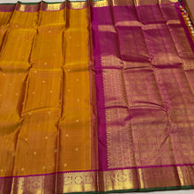 Sahana- Gorgeous Sampanga Mustard with Deep Magenta Buttas Handwoven Pure Jari Kanjivaram Silk with beautiful buttas woven body with mayil chakram motifs woven borders with green selvedges rich pallu and contrast woven blouse