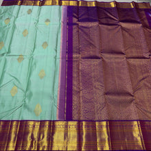 Vaibhogam- Beautiful Pista Green with Purple Handwoven Pure Jari Korvai Kanjivaram Silk with Buttas woven body rich borders pallu and contrast woven blouse