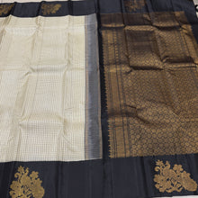 Vaibhogam- Stunning offwhite with black Handwoven Pure Jari Korvai Kanjivaram Silk with beautiful muted checks woven body with gorgeous peacocks woven on either side of the borders with beautiful pallu and contrast black blouse