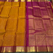 Sahana- Gorgeous Sampanga Mustard with Deep Magenta Buttas Handwoven Pure Jari Kanjivaram Silk with beautiful buttas woven body with mayil chakram motifs woven borders with green selvedges rich pallu and contrast woven blouse