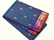Sahana- Gorgeous Dual tone Lavendarish Blue with Purple Small Borders with orange selvedges with Buttas Handwoven Pure Jari Kanjivaram Silk with rich pallu and contrast woven blouse