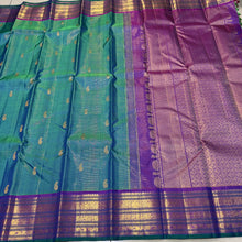 Sahana- Gorgeous Peacock Bluish Green with Purple Handwoven Pure Jari Kanjivaram Silk with Vairaoosi with buttas woven beautiful body with varisaipet borders with green selvedges rich pallu and contrast woven blouse