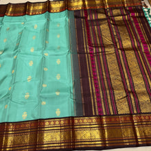 Vaibhogam- Stunning Turquoise Double tone Bluish Green Body with Deep Coffee Brown Handwoven Pure Jari Korvai Kanjivaram Silk with beautiful buttas woven body rich meenakari work woven borders and pallu and contrast woven blouse
