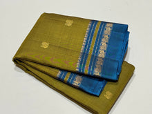 Sahana-Gorgeous Dual tone Sampanga mustard tinted green with teal blue buttas handwoven Pure Kanjivaram with small varisai borders rich buttas woven pallu and contrast woven blouse