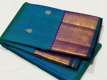 Sahana- Beautiful Peacock Bluish Green with Purple Handwoven Pure Kanjivaram Silk with chakram and thilagam buttas woven body with rich borders beautiful pallu and contrast woven blouse