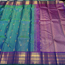 Sahana- Gorgeous Peacock Bluish Green with Purple Handwoven Pure Jari Kanjivaram Silk with Vairaoosi with buttas woven beautiful body with varisaipet borders with green selvedges rich pallu and contrast woven blouse