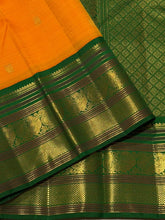 Vaibhogam-Stunning Mango Orange with Emerald Green Handwoven Pure Jari Korvai Kanjivaram Silk with Buttas woven body beautifully woven rich borders pallu and contrast woven green blouse