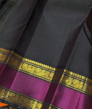 Vaibhogam- Stunning Fanta Orange with Kanchana Black Handwoven Pure Jari Korvai Kanjivaram Silk with beautiful buttas woven body with intricate doublepet with middle silk thread woven borders gorgeous kalakshetra parrots woven pallu and contrast blouse