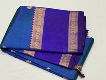 SahanaPeacock  Bluish Green  with Royal Blue Handwoven Pure Kanjivaram Silk Saree with beautiful deers and peacocks motifs woven body with rettapet borders rich vanasingaram style woven pallu with elephants peacocks under a tree and contrast blouse.